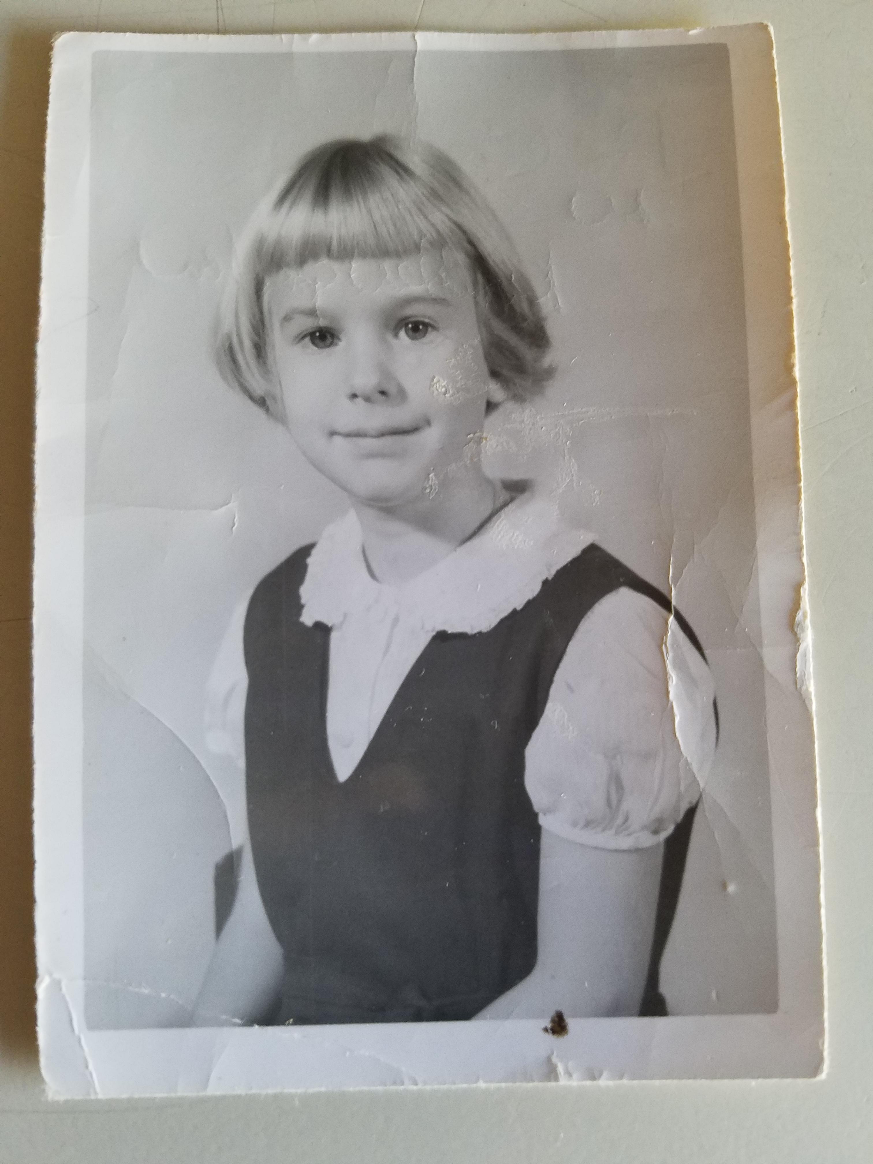 Mary (Stohr) Rhoades in 1st Grade Jumper Uniform (before green plaid uniform became the rule)